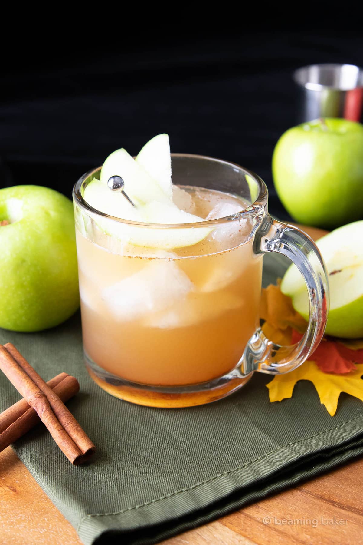 apple juice cocktail topped with an apple slice garnish