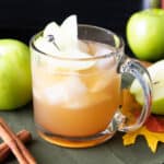 apple juice cocktail in a glass mug with apple garnish