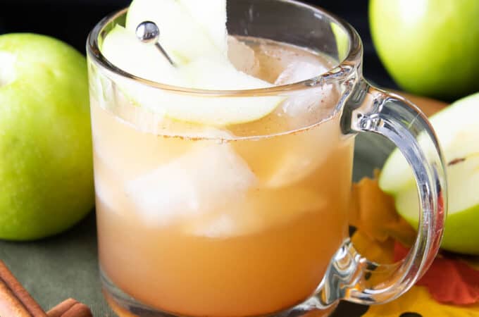 apple juice cocktail in a glass mug with apple garnish