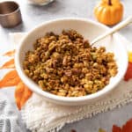bowl of pumpkin granola with a gold spoon
