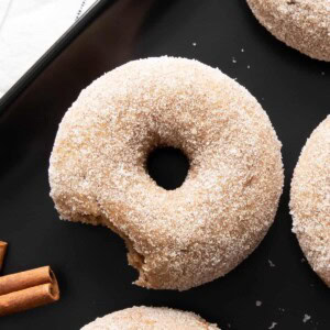 bitten donut on a black ceramic tray