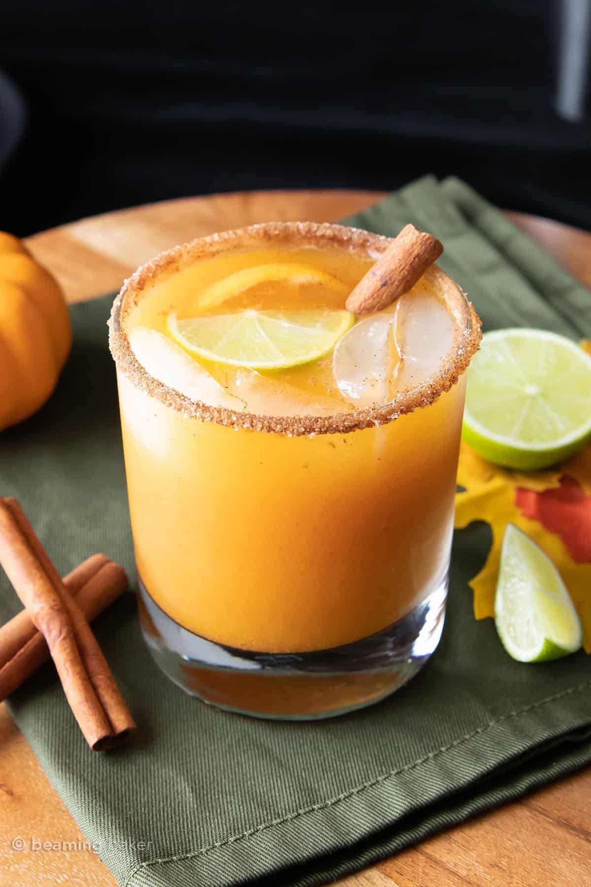 a pumpkin cocktail topped with a fresh lime