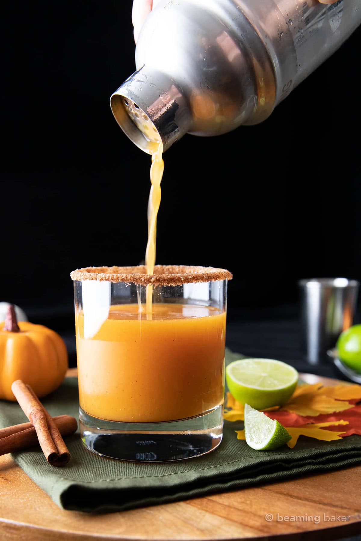 filling rimmed glass with pumpkin cocktail