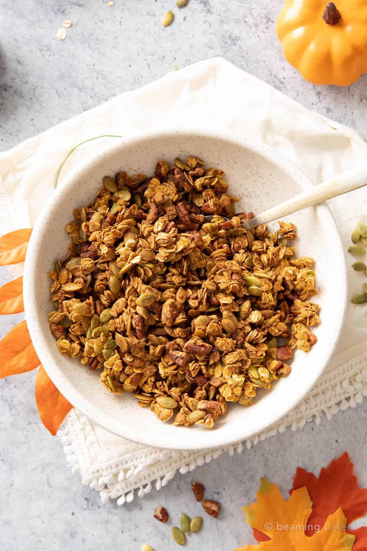 pumpkin flax granola in a bowl with a gold spoon