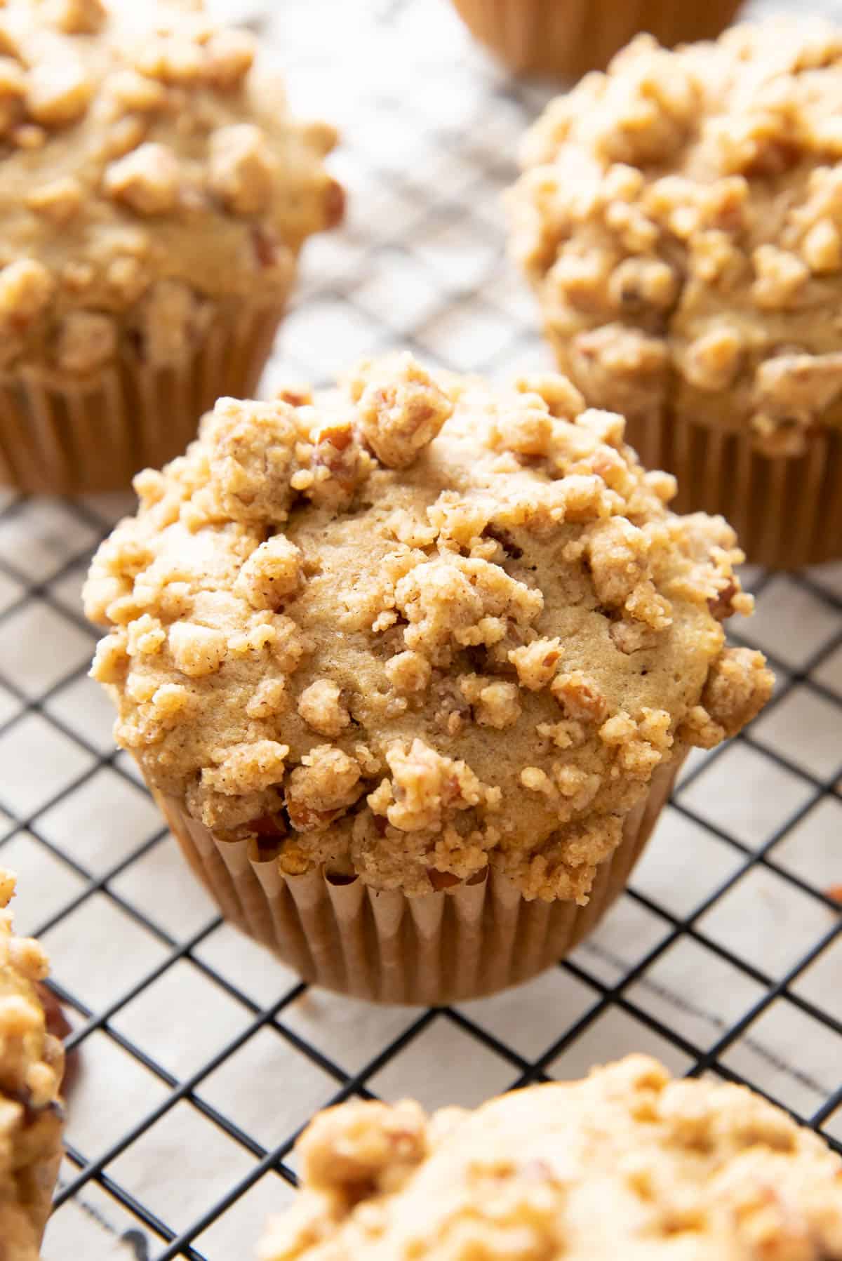 Angled photo of cinnamon streusel muffins to show crumbly topping