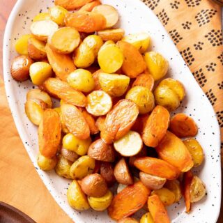 roasted potatoes and carrots in a serving dish
