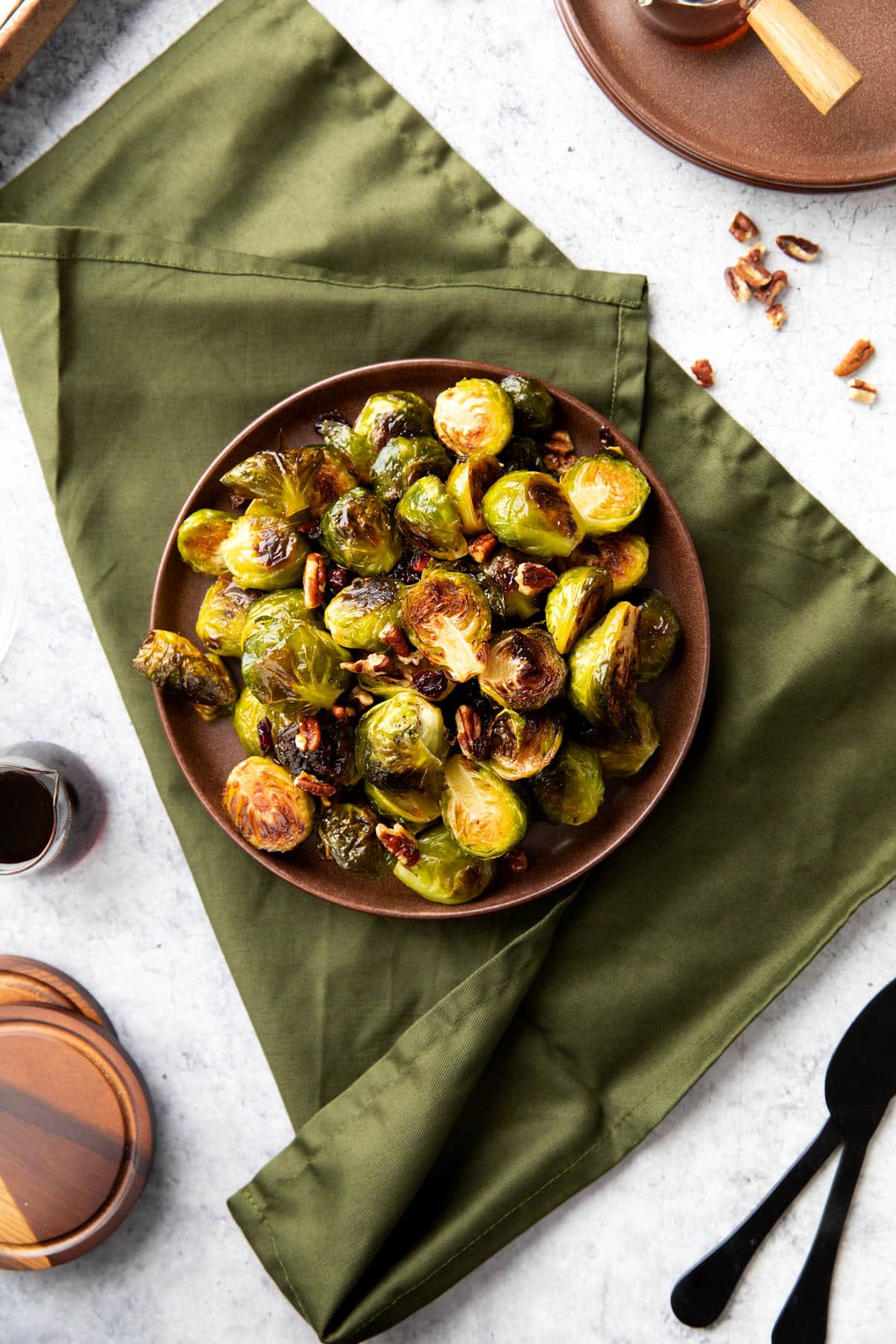 Brussel sprouts with maple syrup glazed and drizzled on top served on a table.