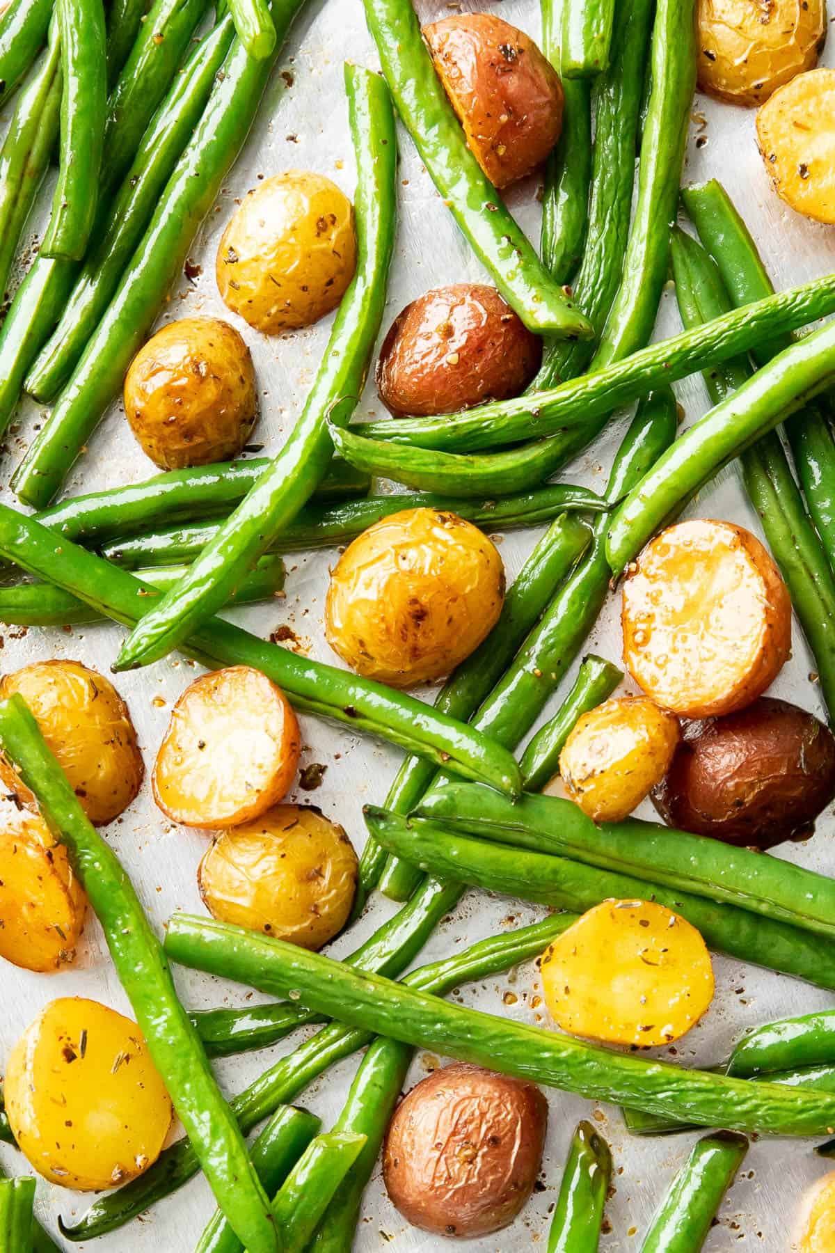 roasted green beans and potatoes on foil lined tray