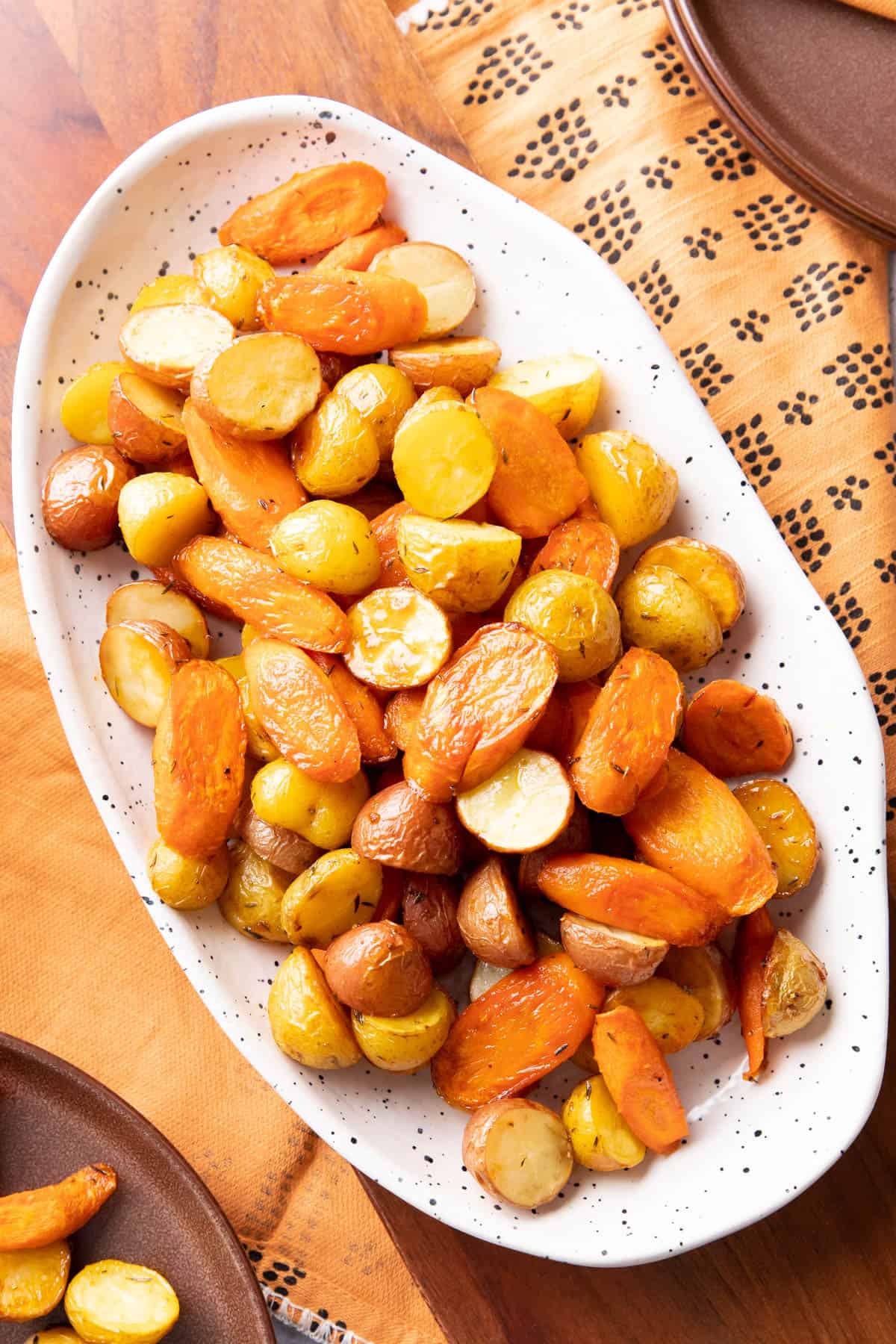 Serving dish of roasted potatoes and carrots