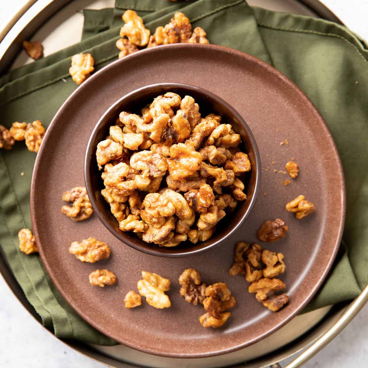 serving tray with candied walnuts in a bowl
