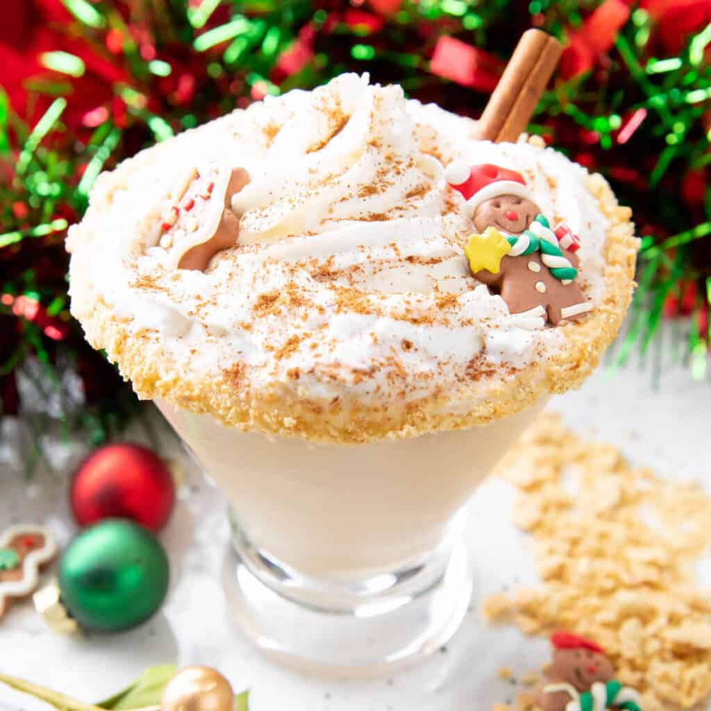 a gingerbread martini topped with whipped cream and gingerbread cookies