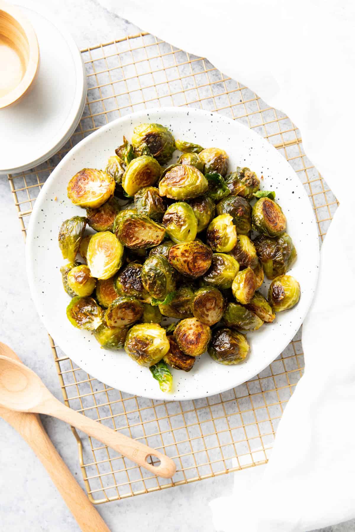 vegan brussel sprout recipe served on a table with napkins and utensils 