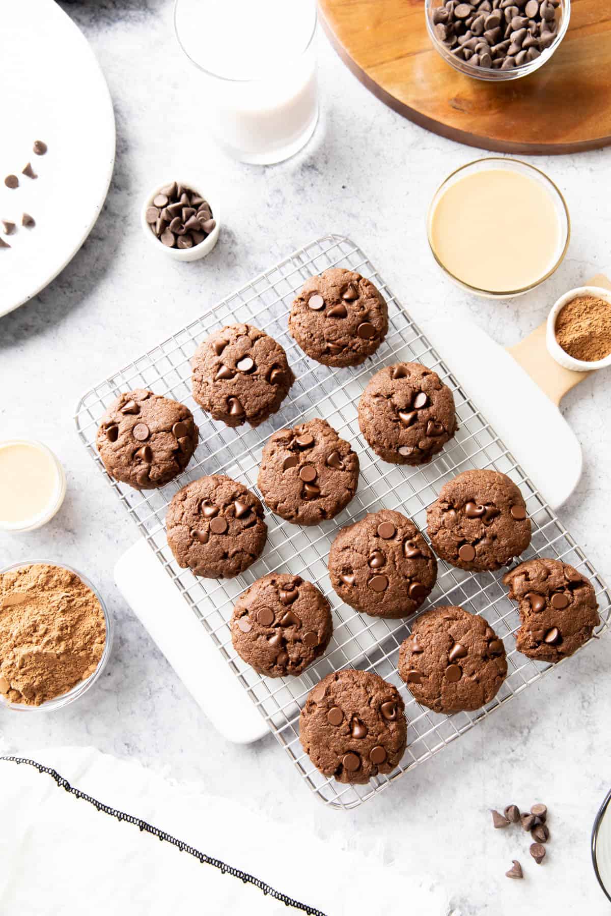 Dark chocolate cookies and ingredients laid out on a marble kitchen table