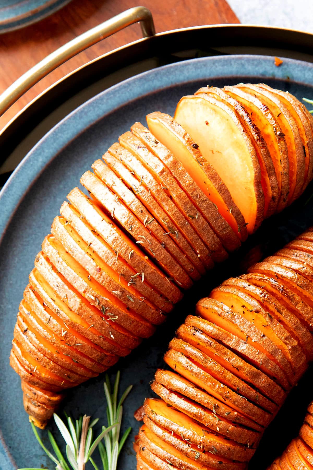 close up of Hasselback sweet potato that's sliced and fanned out with crisp edges and tender centers