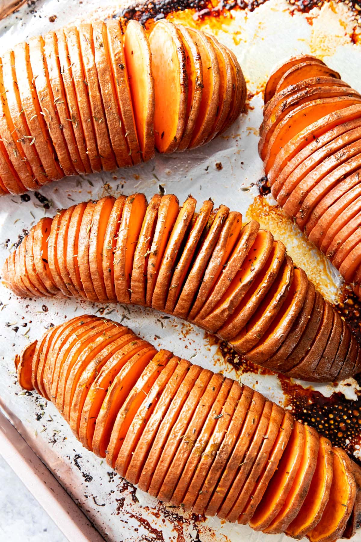 this Hasselback sweet potatoes recipe finished baking on a foil-lined baking sheet