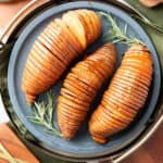 square photo of hasselback sweet potatoes on a blue plate