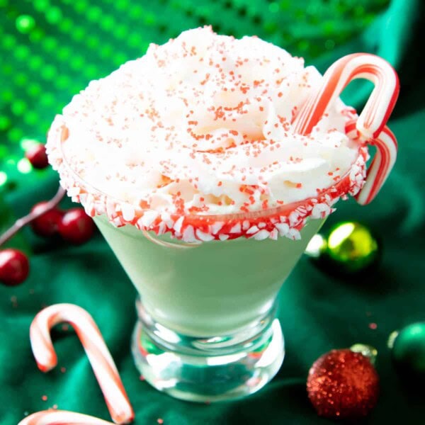 square photo of a peppermint martini against a green backdrop