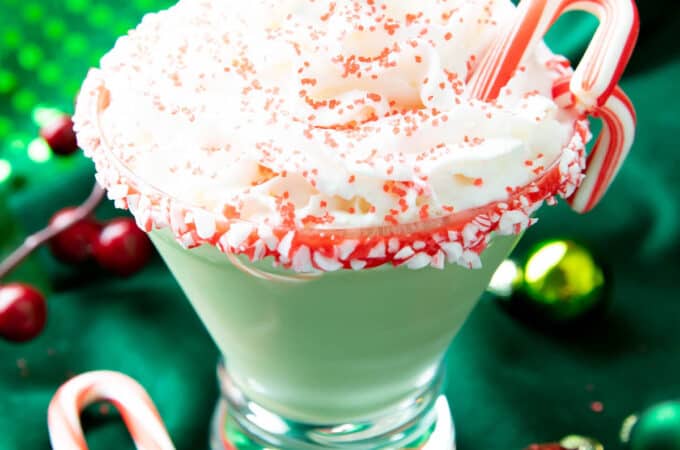 square photo of a peppermint martini against a green backdrop