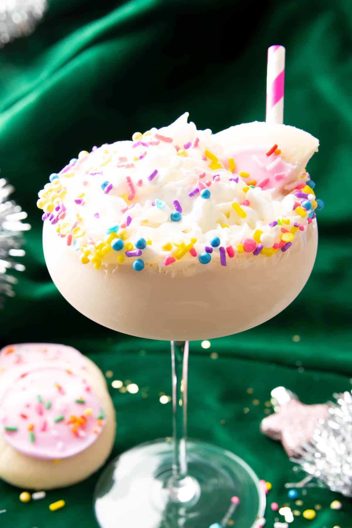 Sugar cookie martini with sprinkles and pink straw