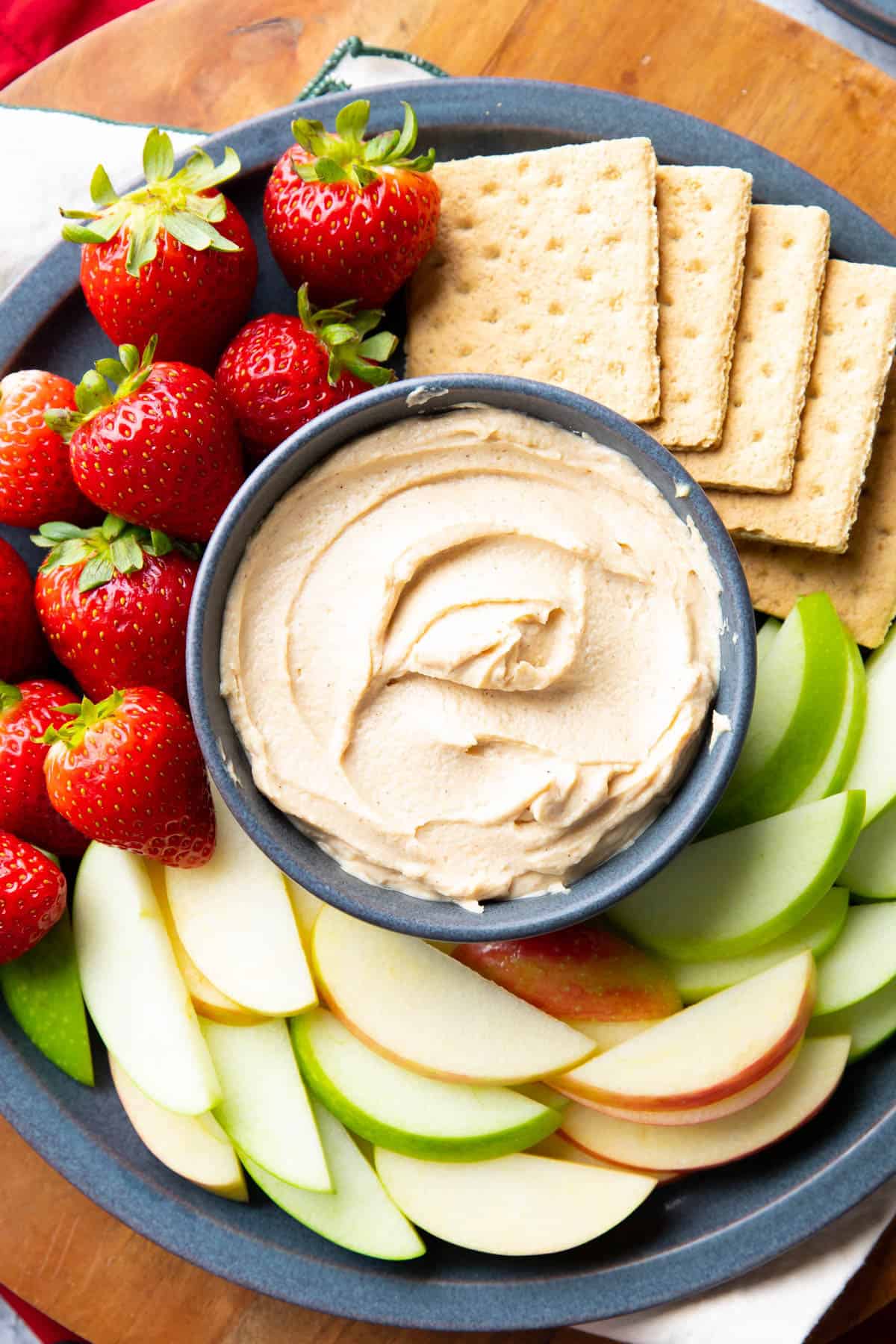 Peanut butter dip on a serving tray with fruits