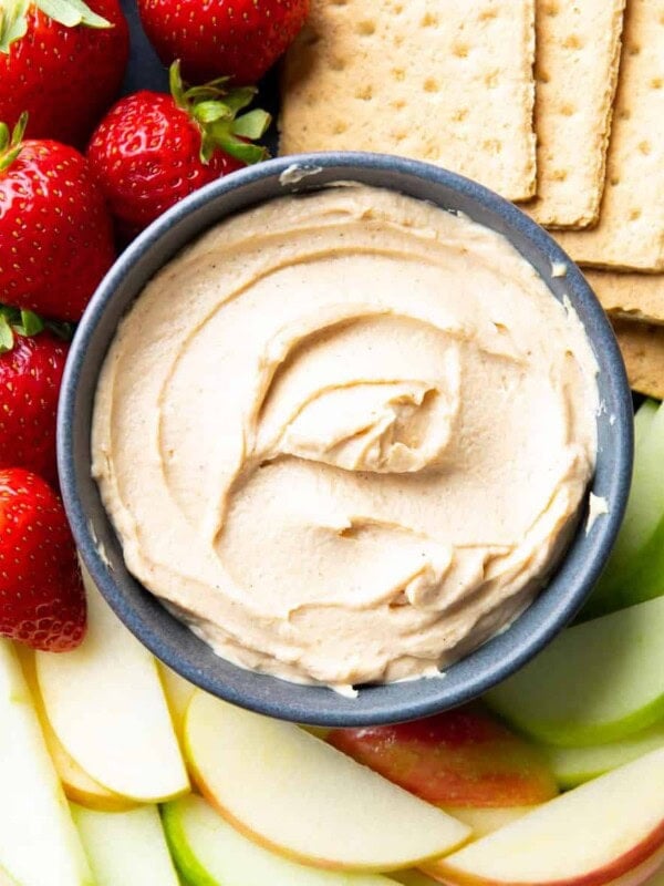 square photo of peanut butter dip served with fruits