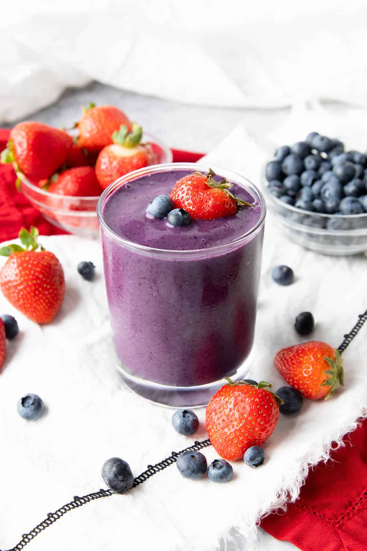 Strawberry Blueberry Smoothie on a table with fresh fruits 