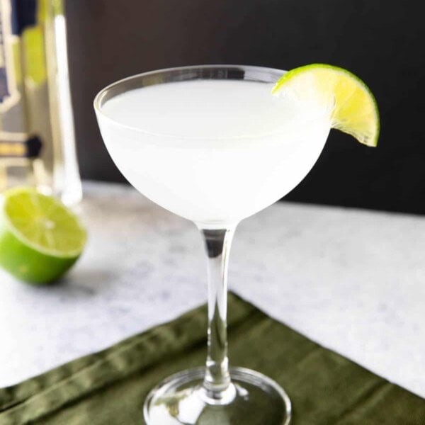 French Gimlet on a black background with a lime wedge