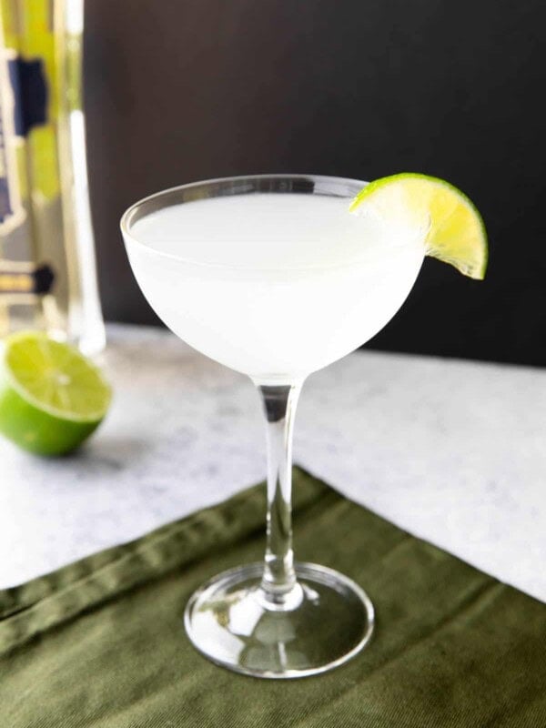 French Gimlet on a black background with a lime wedge