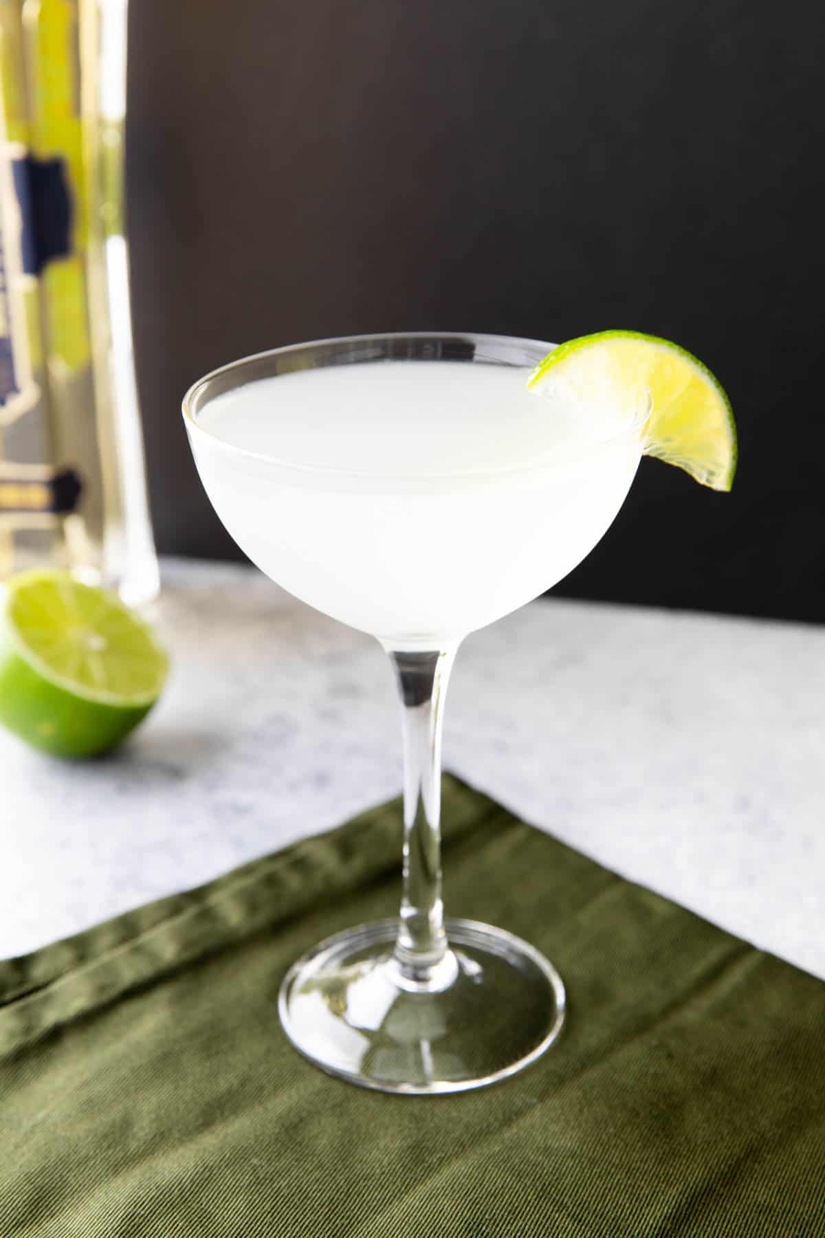 French Gimlet on a black background with a lime wedge