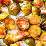 closeup photo of honey sriracha Brussels sprouts on a foil-lined tray