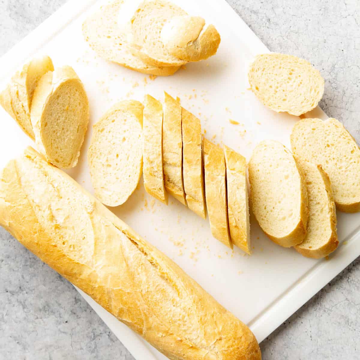 A photo showing How to Make Garlic Toast – slicing baguettes