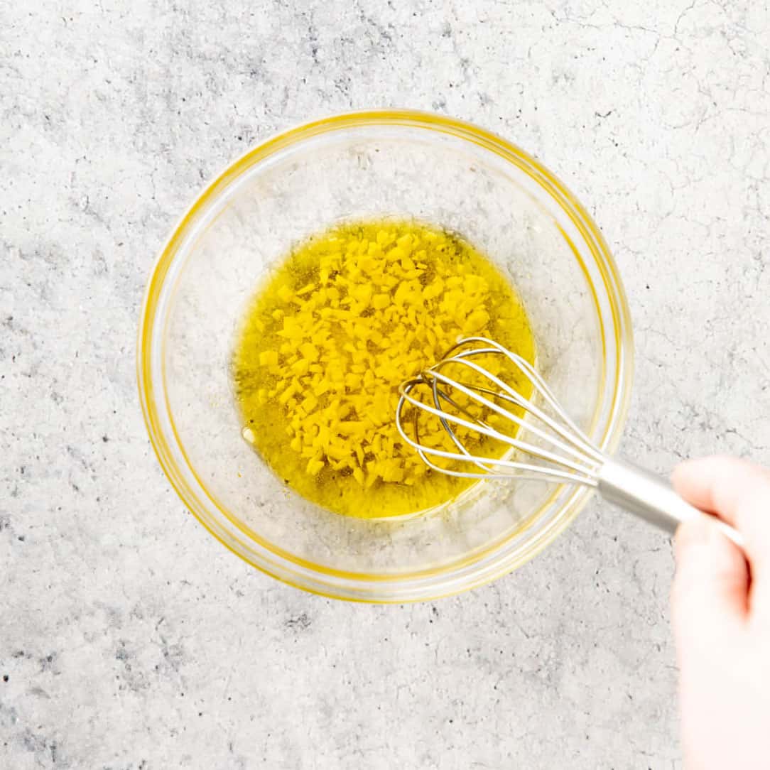 One photo showing How to Make this recipe – whisking the garlic oil mixture