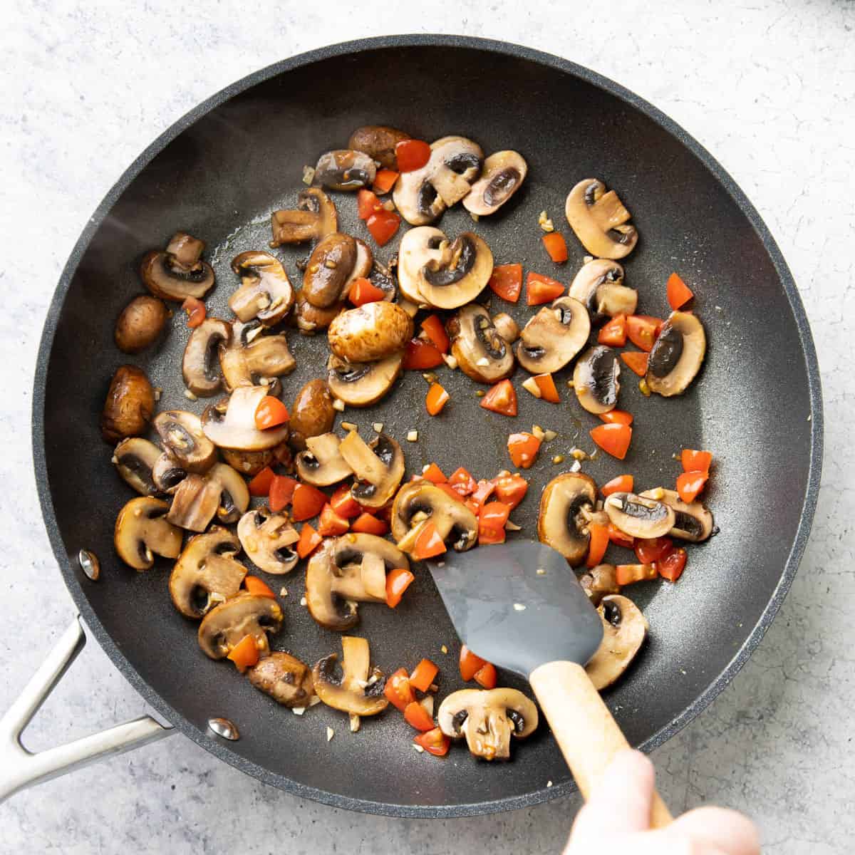 One photo showing How to Make a Mushroom Quesadilla – adding in vegetables