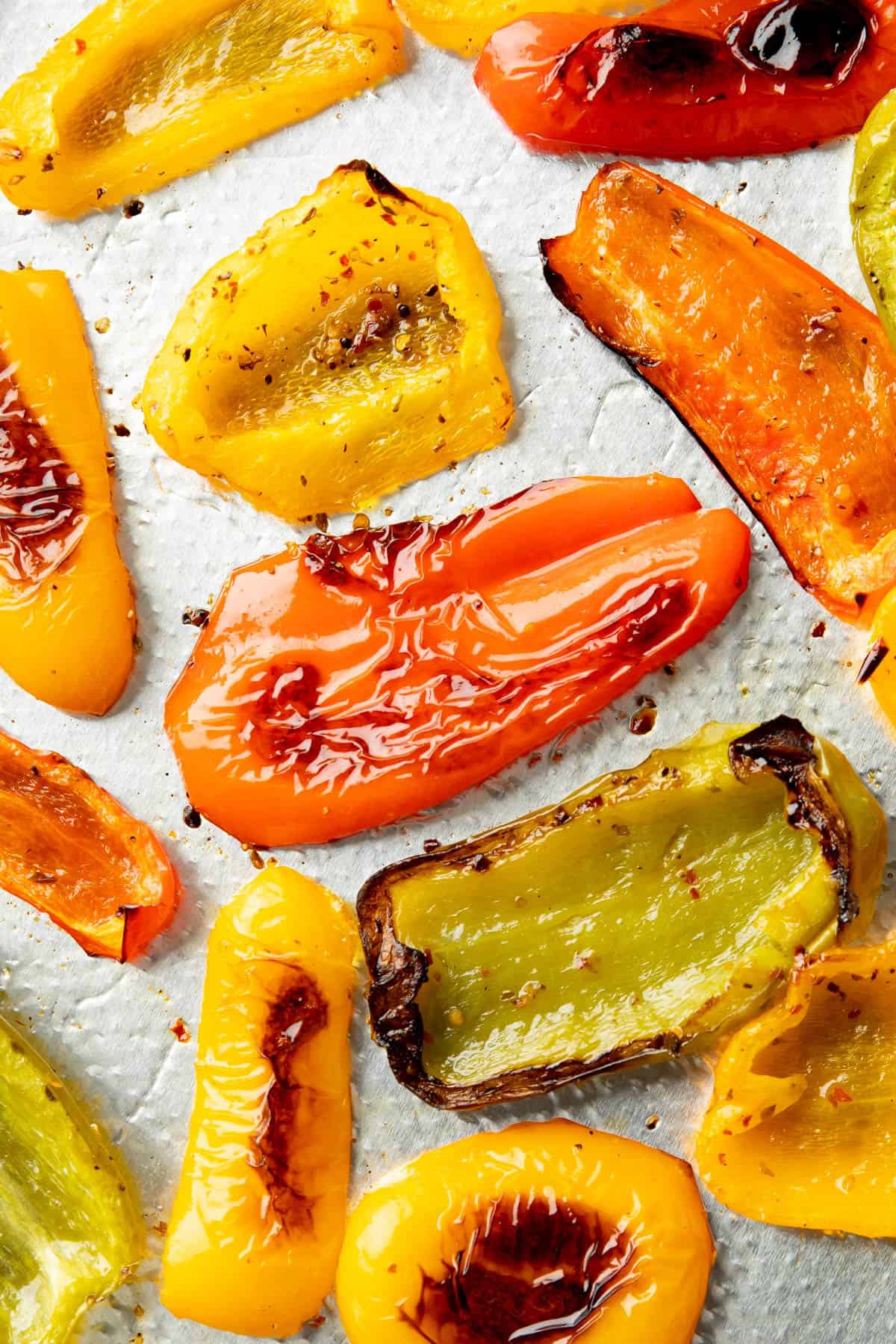 Closeup photo of roasted bell peppers on a baking sheet