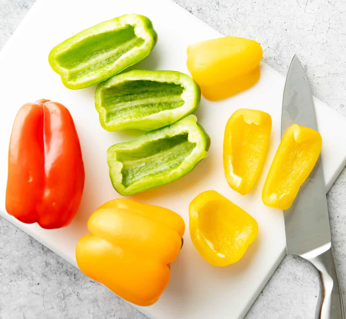 Photo showing How to make Roasted Bell Peppers – Slicing bell peppers on a cutting board