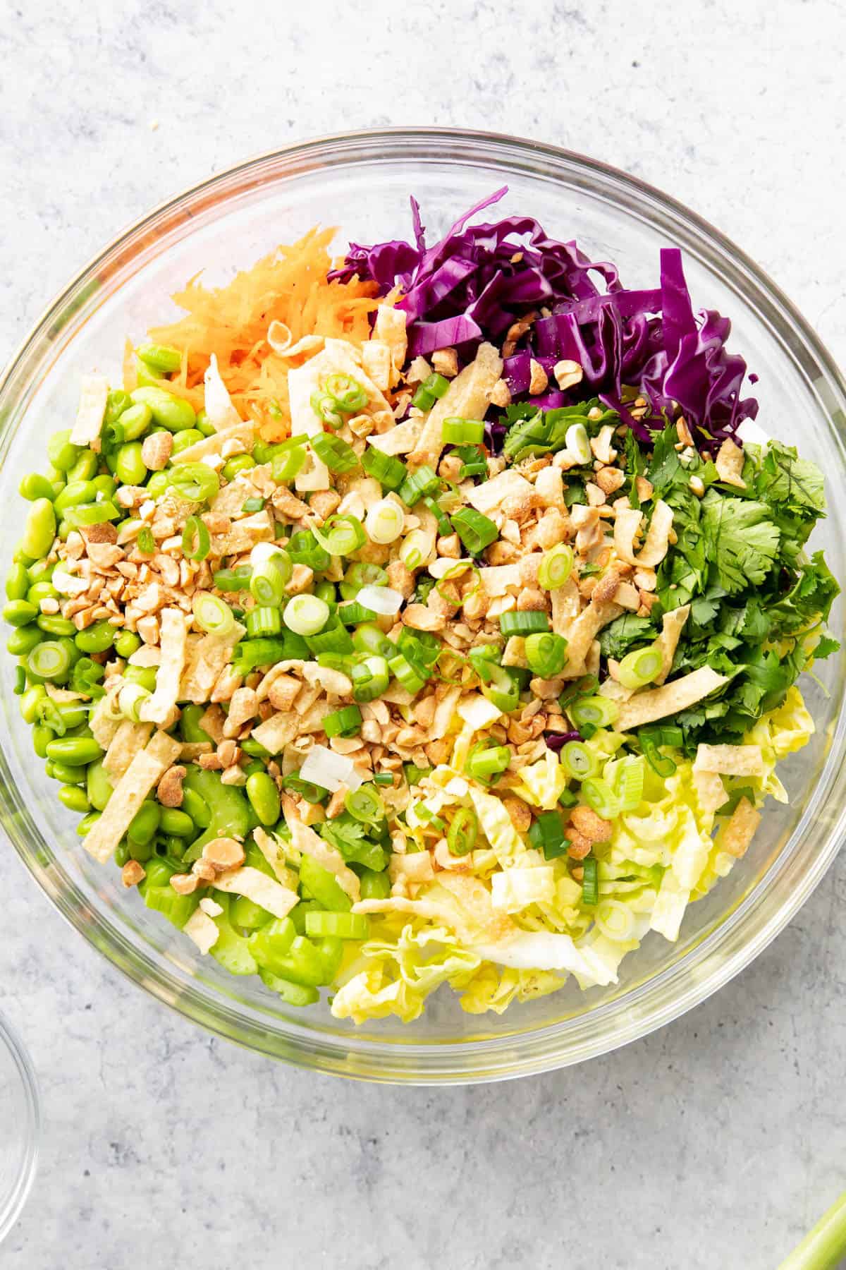 Asian salad prepared chopped vegetables in glass mixing bowl