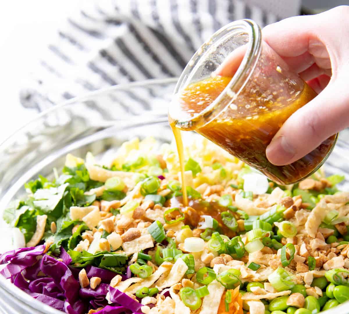 pouring this Asian Salad Dressing recipe over an Asian Salad 