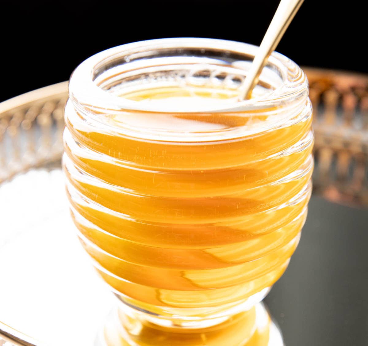 Jar of homemade honey syrup, a key ingredients in the bees knees cocktail