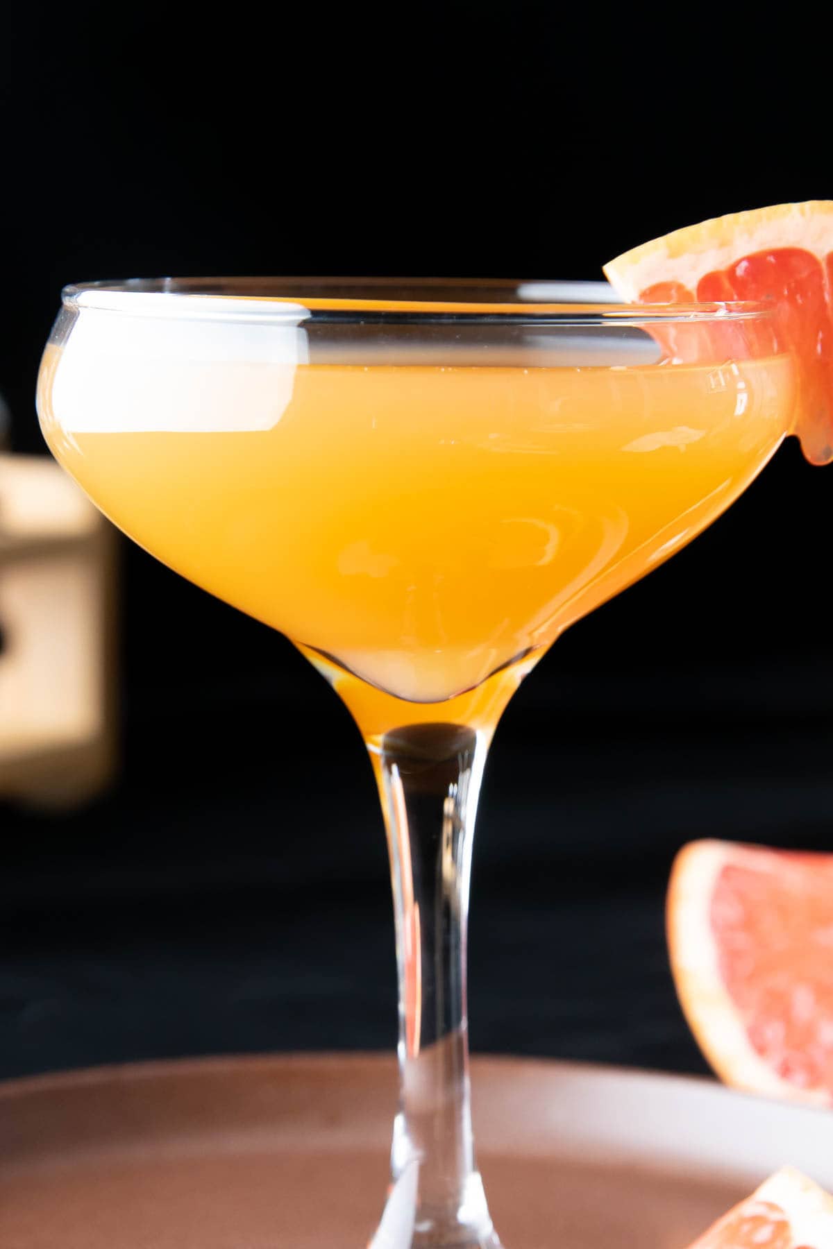 closeup photo of brown derby drink with a grapefruit garnish