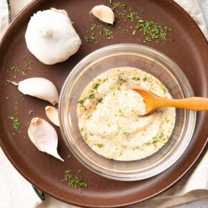 square photo of garlic salt in a glass serving bowl