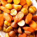close up of roasted carrots and potatoes to show butter, herbs, and other seasonings that coat this recipe