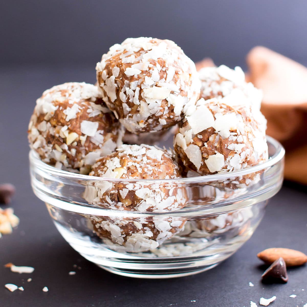 Glass bowl filled with no bake snacks with coconut, almonds, and chocolate chips