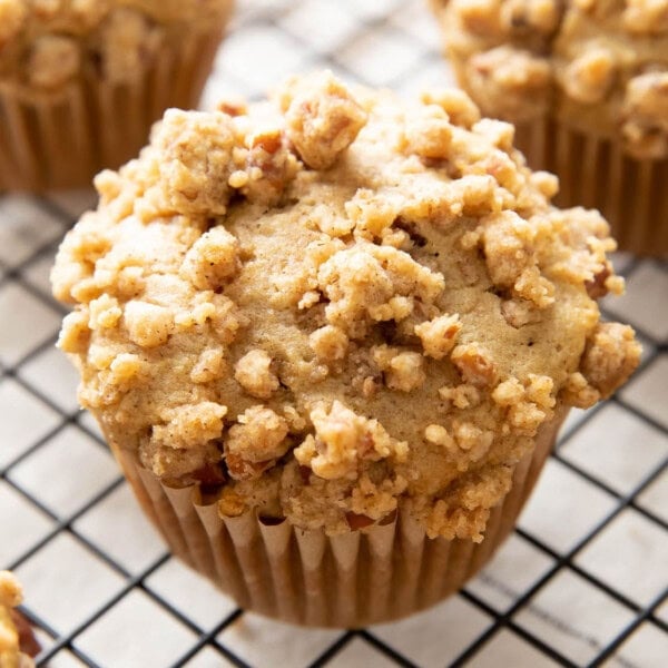 Cinnamon Streusel Muffins on a black cooling rack.