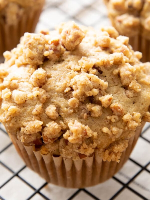 Cinnamon Streusel Muffins on a black cooling rack.