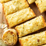 close up of roasted garlic bread with loads of butter, roasted garlic on toasted bread