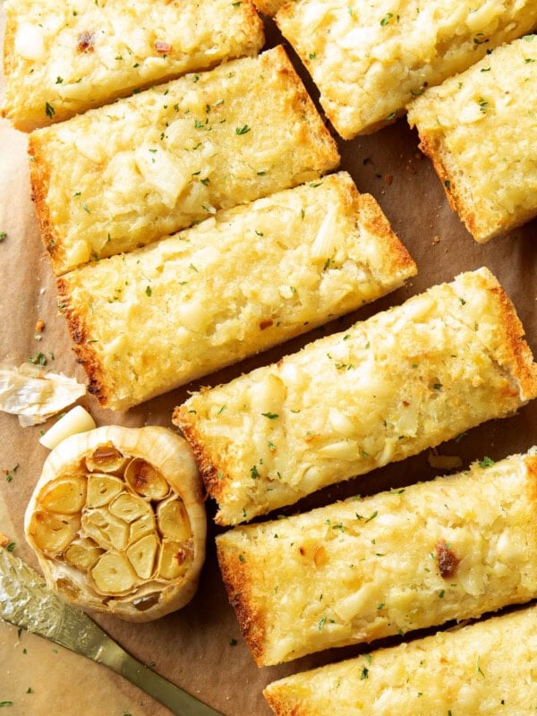 close up of roasted garlic bread with loads of butter, roasted garlic on toasted bread