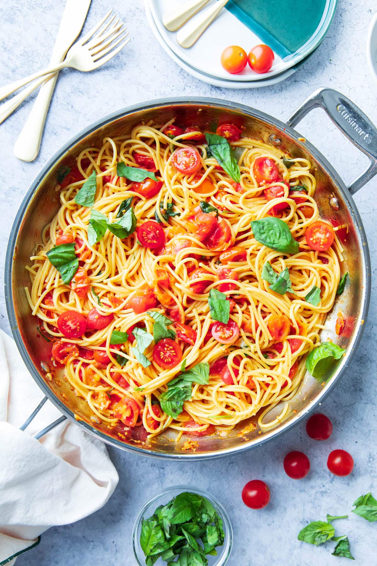 Tomato Basil Pasta in a skillet topped with fresh basil leaves