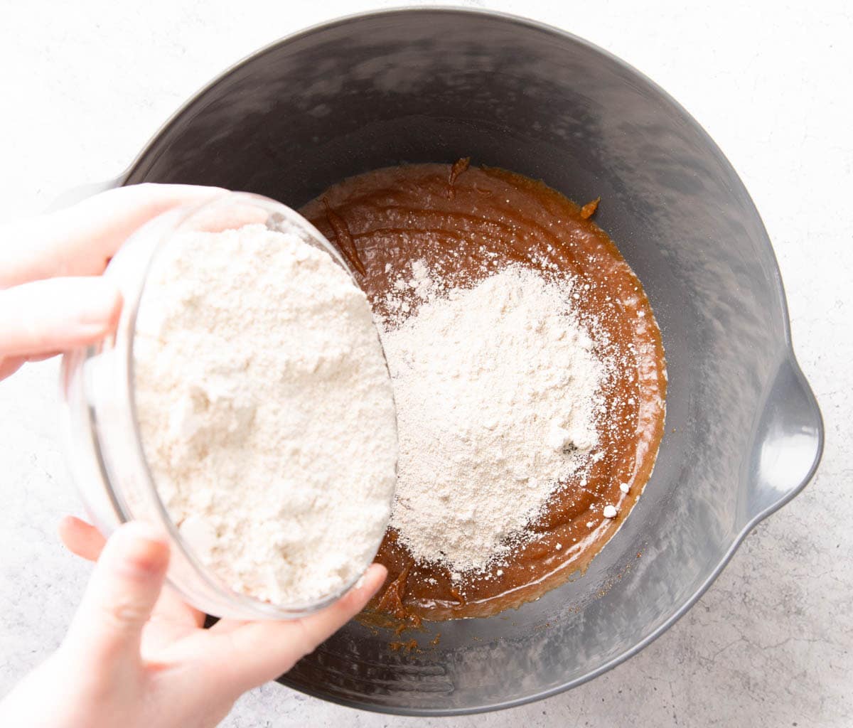 Two photos showing How to Make Vegan Gluten Free Pumpkin Bread – pouring flour over wet ingredients