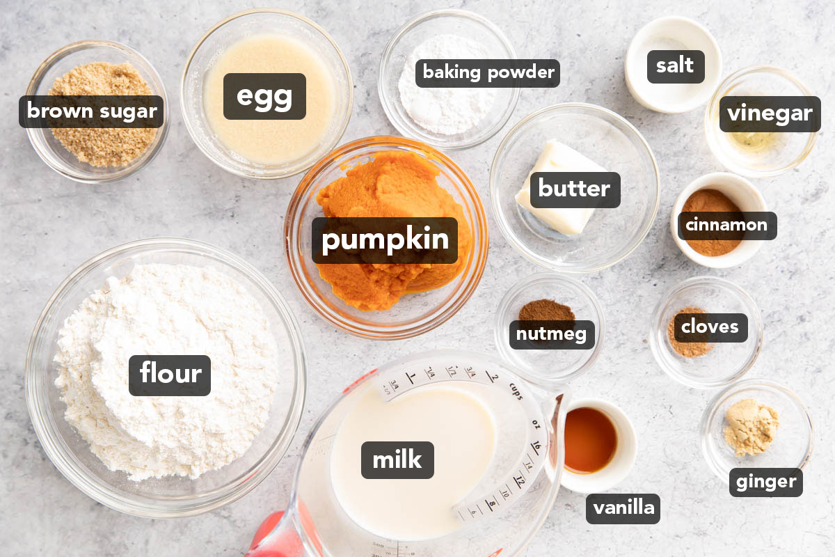 Pre-measured ingredients for Pumpkin Pancakes in prep bowls including pumpkin puree, vanilla extract, flour, brown sugar, cinnamon, and homemade buttermilk
