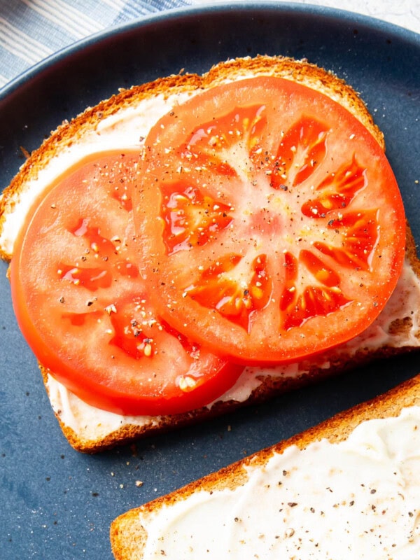 thick tomato slices on top of mayo over bread for a Tomato Sandwich